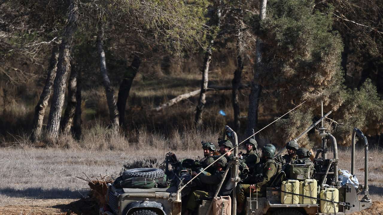 Israeli soldiers sit in a military vehicle on a road towards the Gaza Strip, amid the ongoing conflict between Israel and Hamas, in southern Israel, January 1, 2025. REUTERS/Kai Pfaffenbach