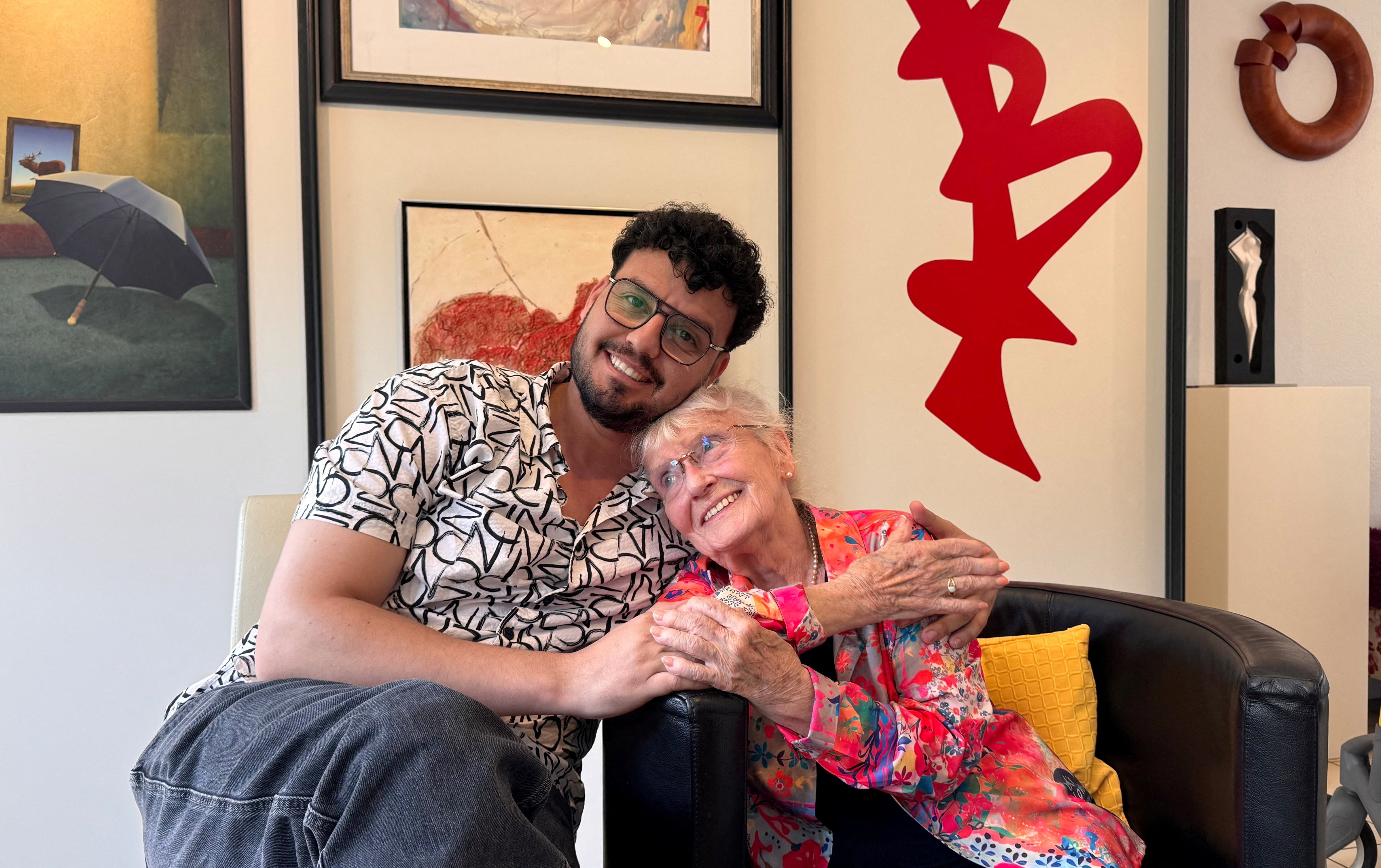 Iraqi refugee Humam Al-Gburi, 34, and retired nurse Ursula Panke, 85, pose for a picture in Altena