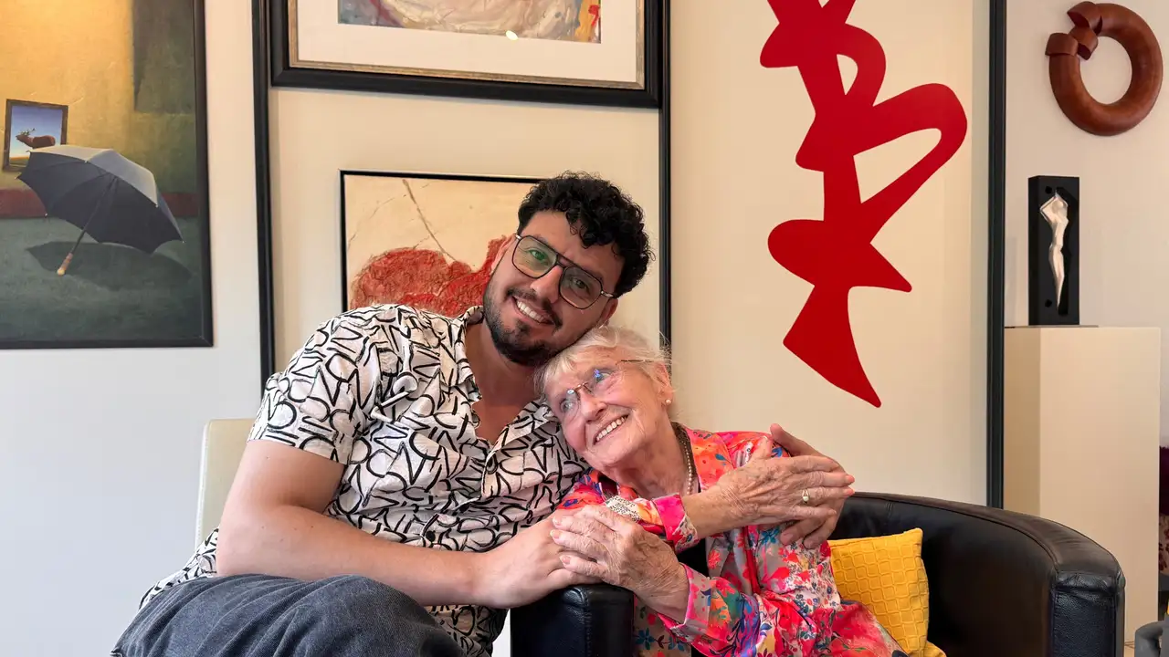 Iraqi refugee Humam Al-Gburi, 34, and retired nurse Ursula Panke, 85, pose for a picture in Altena