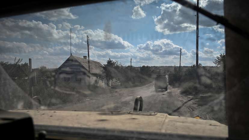 A military vehicle carrying servicemen of Ukraine’s 3rd Separate Assault Brigade drives down a road during a reconnaissance mission near Bakhmut