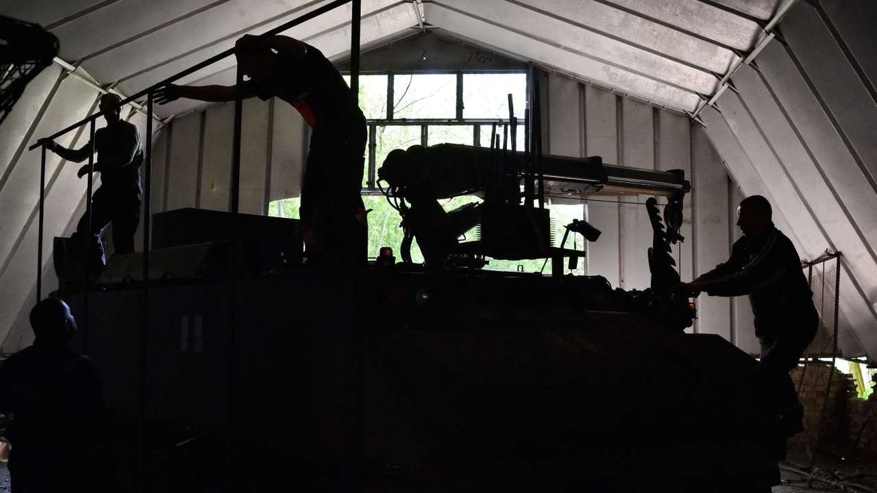 Ukrainian servisemen install an anti-drone protection to an armored repair and recovery vehicle in Zaporizhzhia region