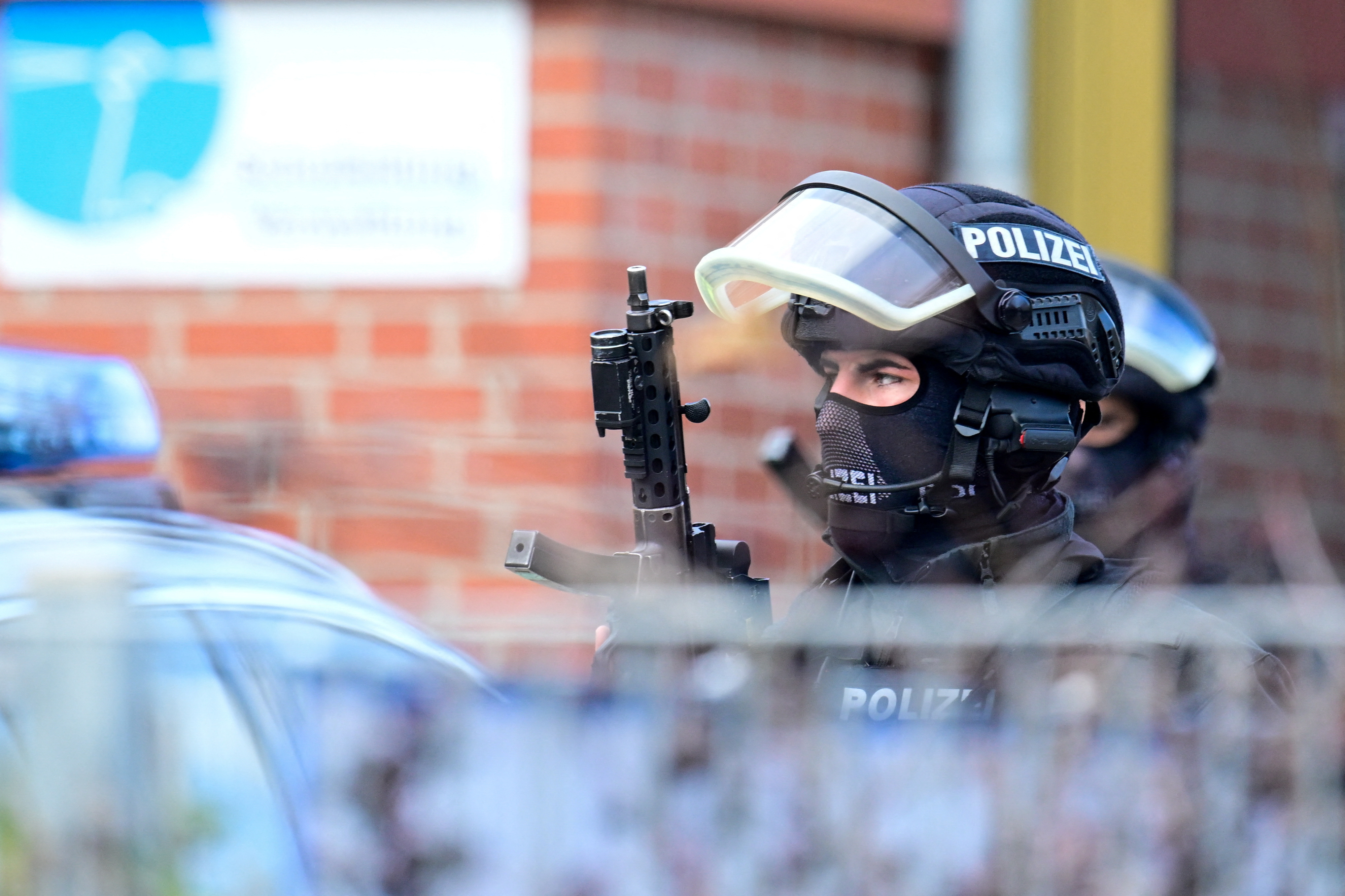 Police secure the area after local media said that two armed people had barricaded themselves in a classroom, in Hamburg
