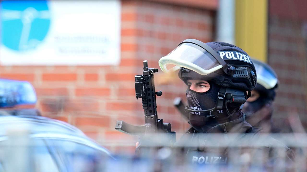 Police secure the area after local media said that two armed people had barricaded themselves in a classroom, in Hamburg