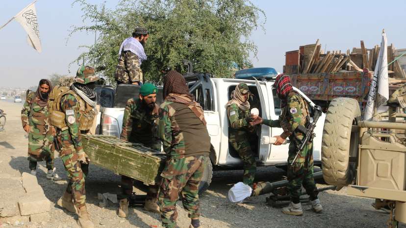 Taliban soldiers carry rocket launcher in a vehicle near Torkham border