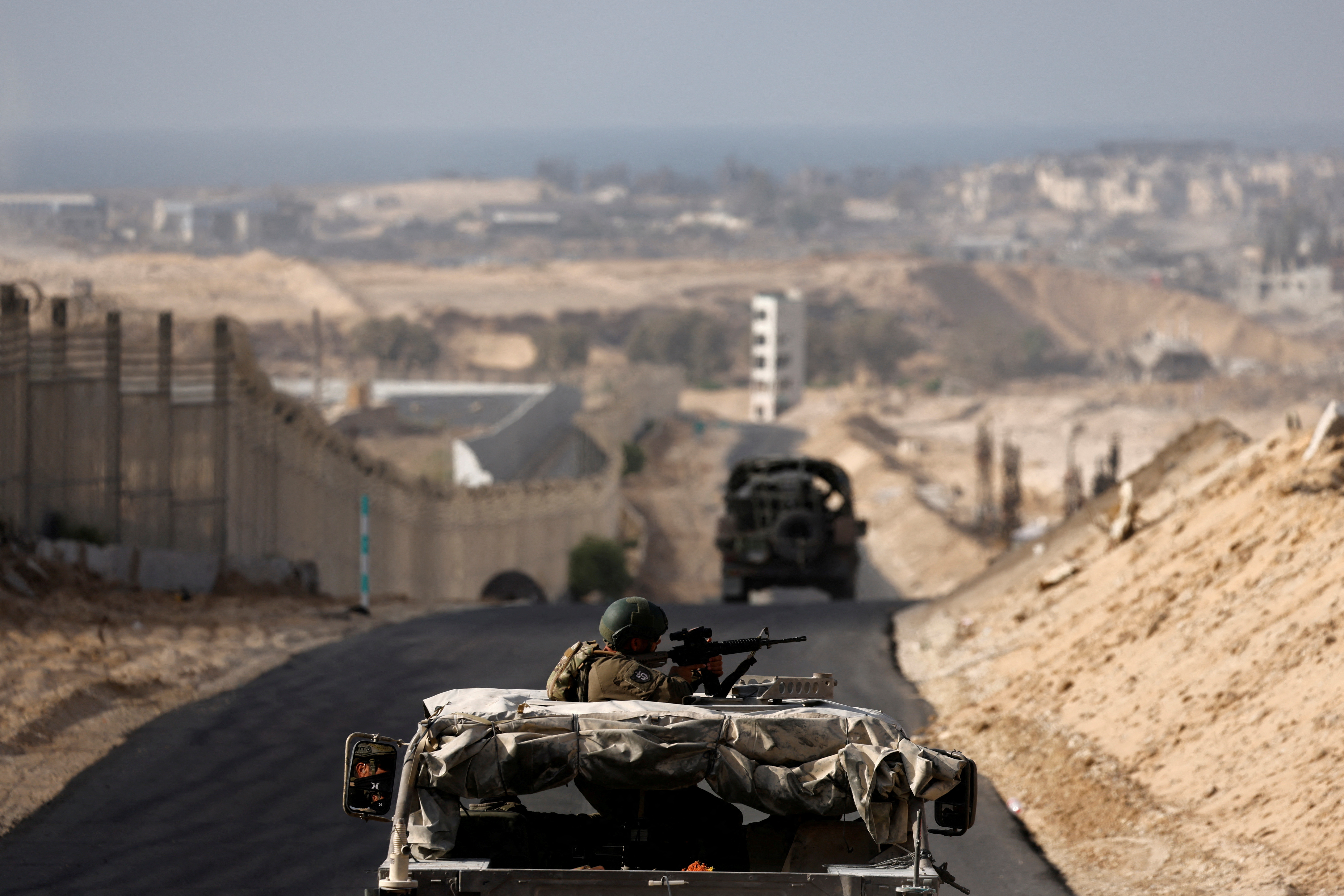 Israeli military vehicles drive through the Philadelphi Corridor area in southern Gaza