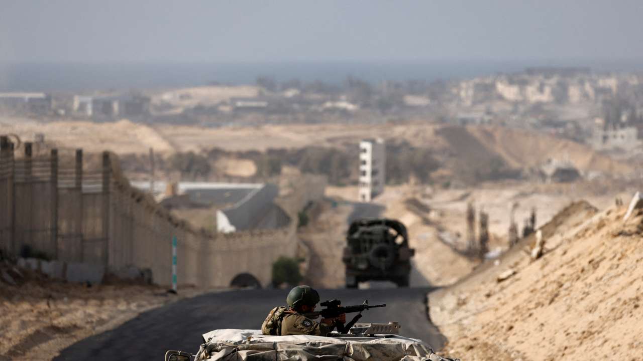 Israeli military vehicles drive through the Philadelphi Corridor area in southern Gaza