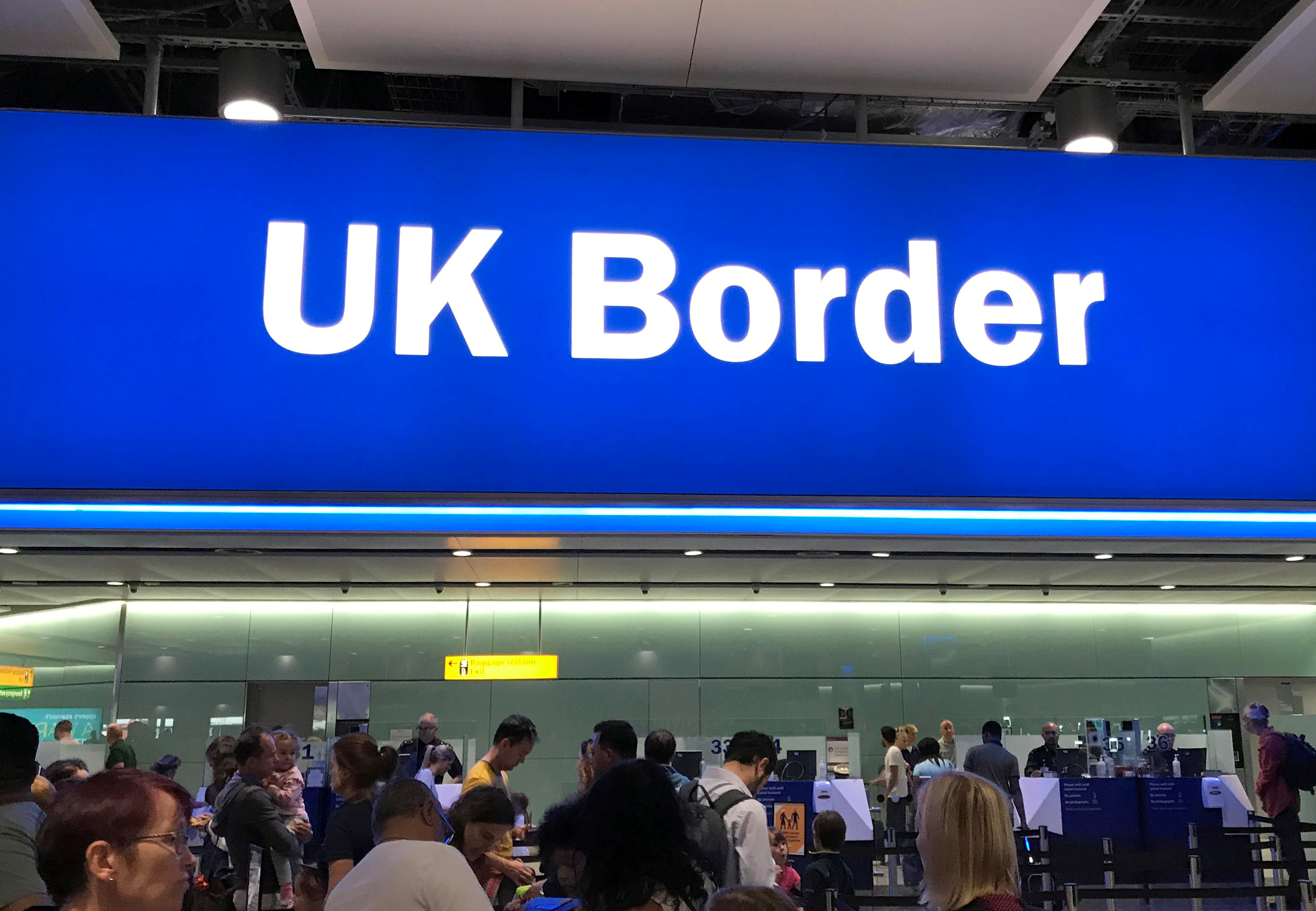 Signage is seen at the UK border control point at the arrivals area of Heathrow Airport, London