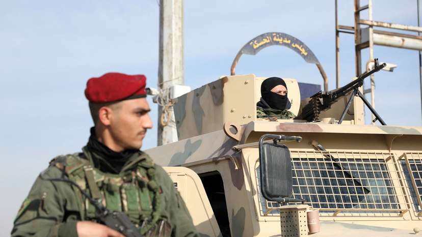 FILE PHOTO: Member of Kurdish-led Syrian Democratic Forces (SDF) stands along a street in Hasakah