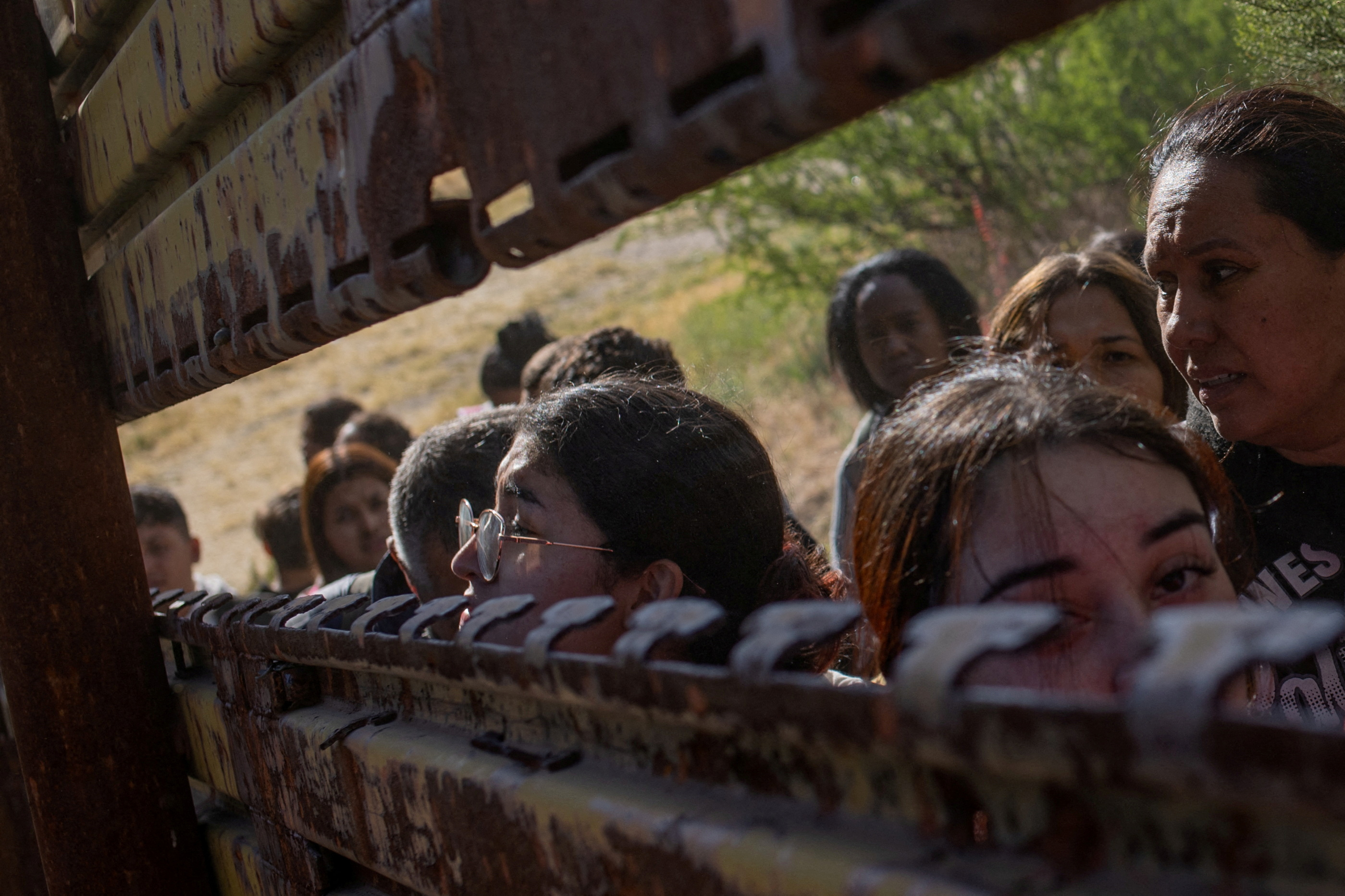 FILE PHOTO: Female migrants from South and Central America look towards U.S. from Mexico