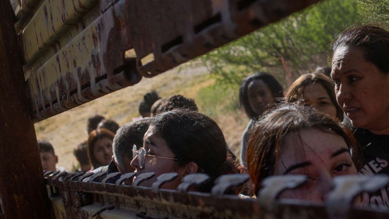 FILE PHOTO: Female migrants from South and Central America look towards U.S. from Mexico