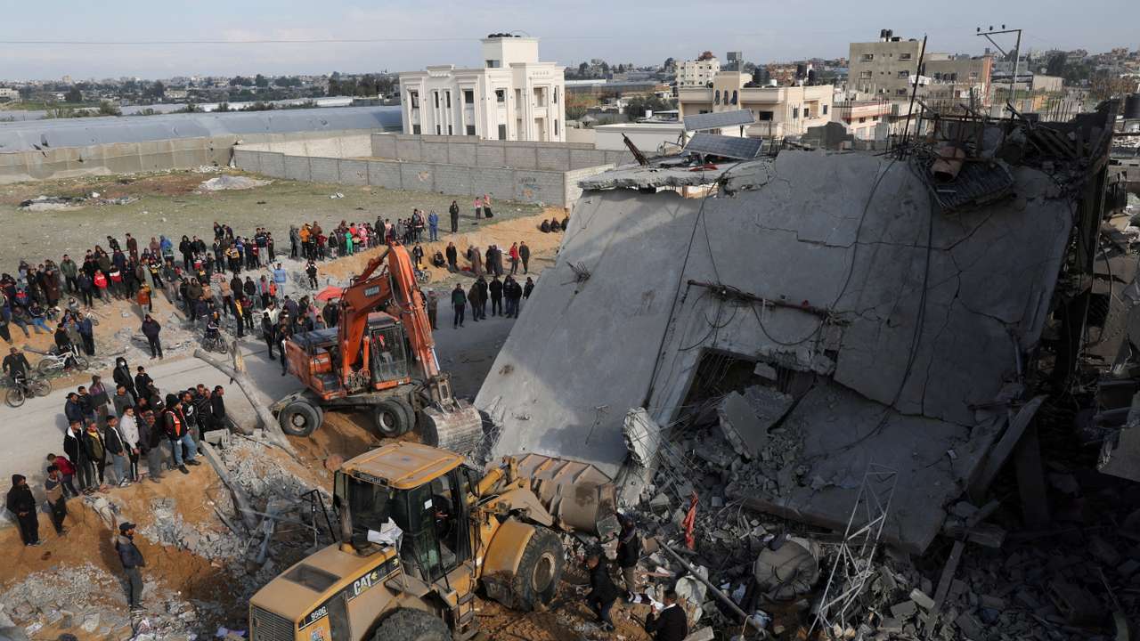 FILE PHOTO: Palestinians inspect a house hit by an Israeli strike, in Rafah in the southern Gaza Strip