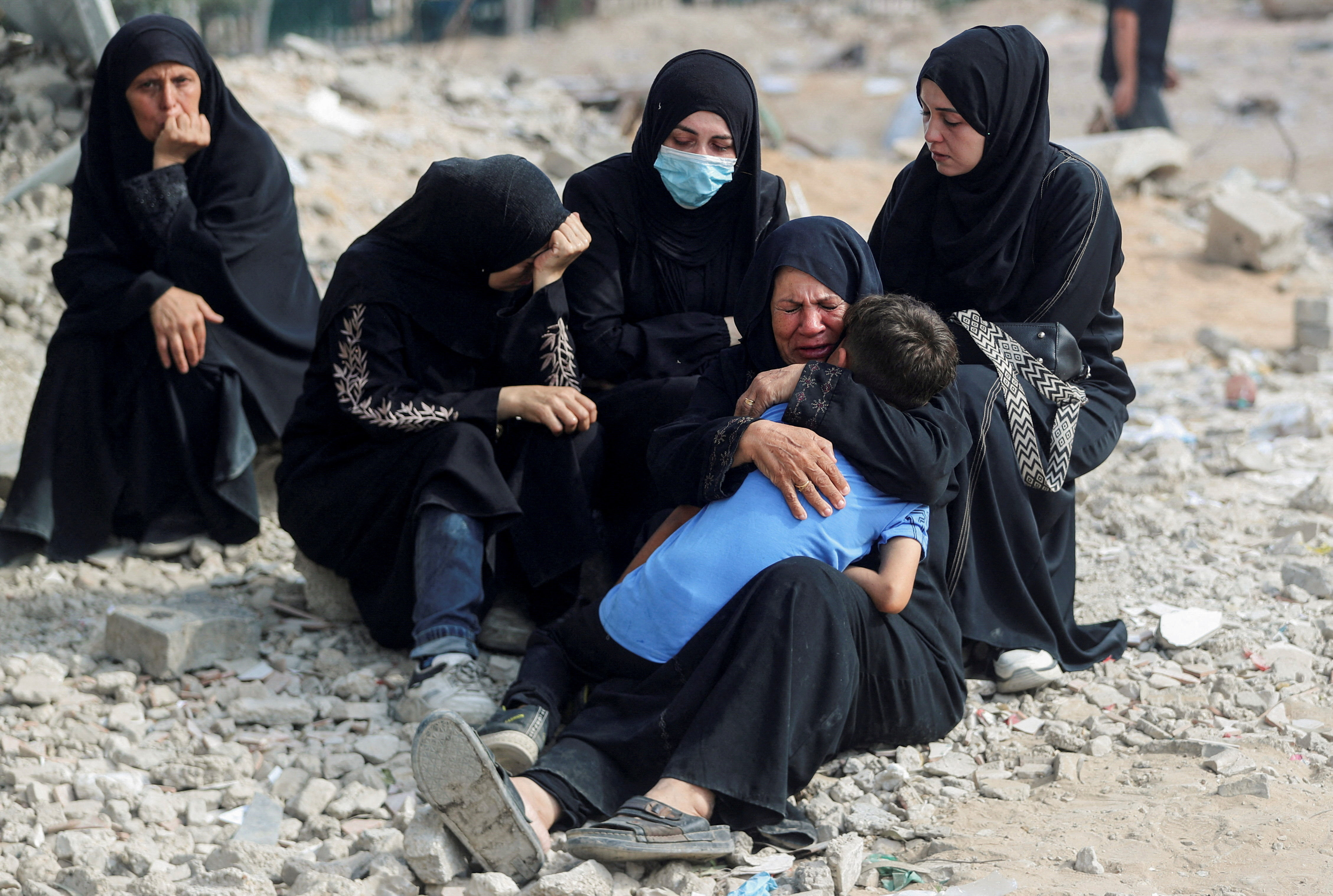 FILE PHOTO: Palestinians mourn loved ones killed in Israeli fire, in Gaza City