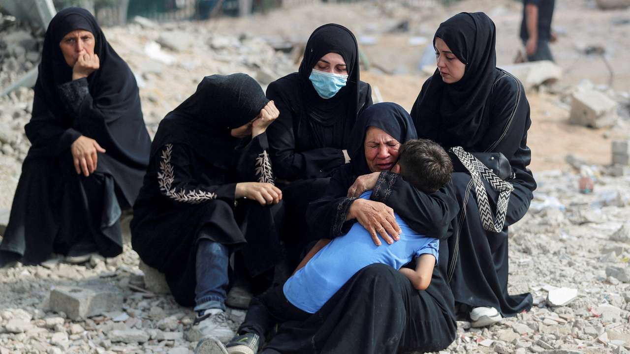 FILE PHOTO: Palestinians mourn loved ones killed in Israeli fire, in Gaza City