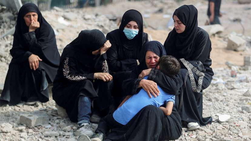 FILE PHOTO: Palestinians mourn loved ones killed in Israeli fire, in Gaza City