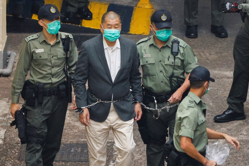 FILE PHOTO: Media mogul Jimmy Lai Chee-ying, founder of Apple Daily, walks to a prison van to head to court, after being charged under the national security law, in Hong Kong