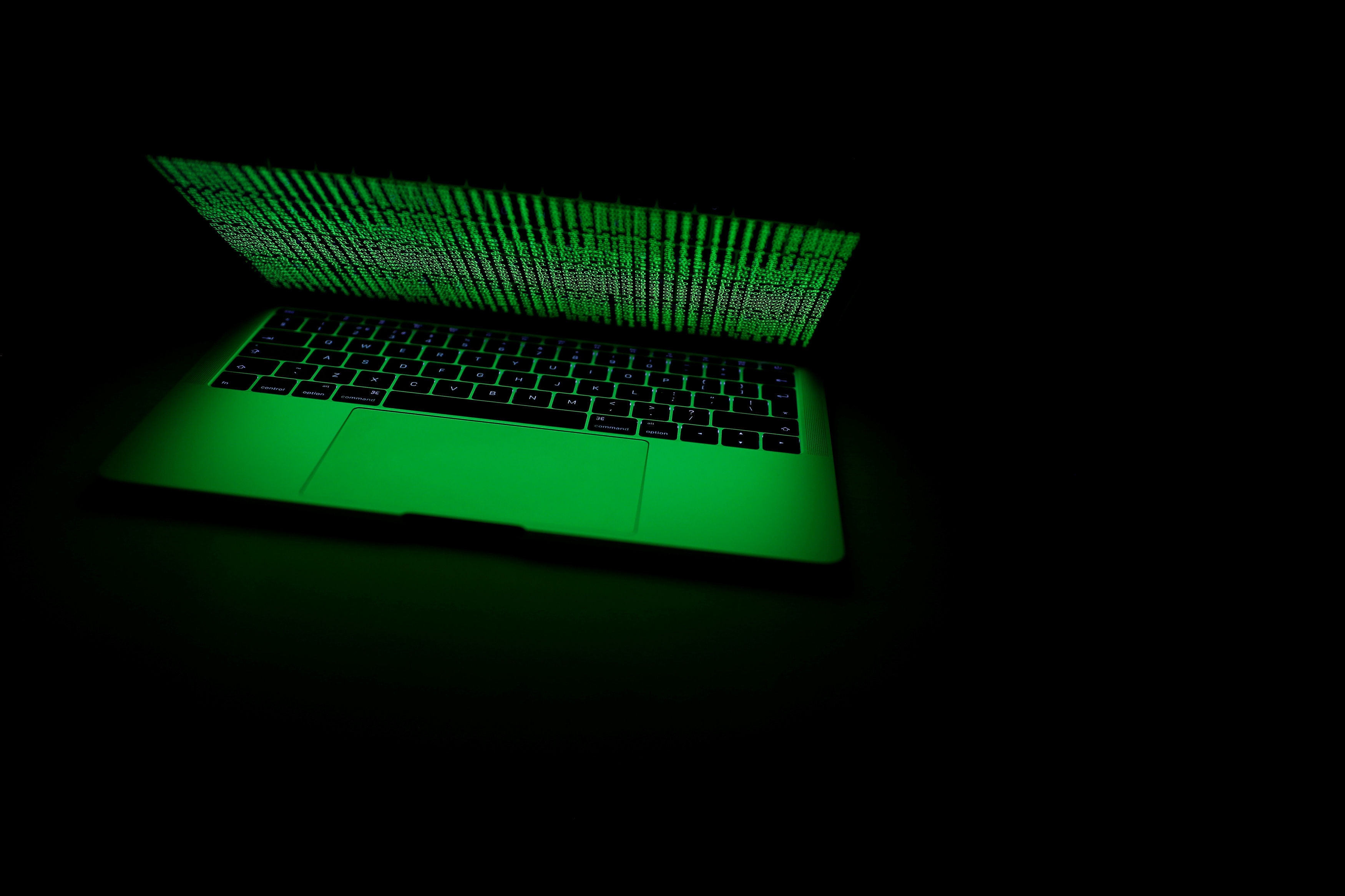 A computer lit by a displayed cyber code is seen in this illustration picture