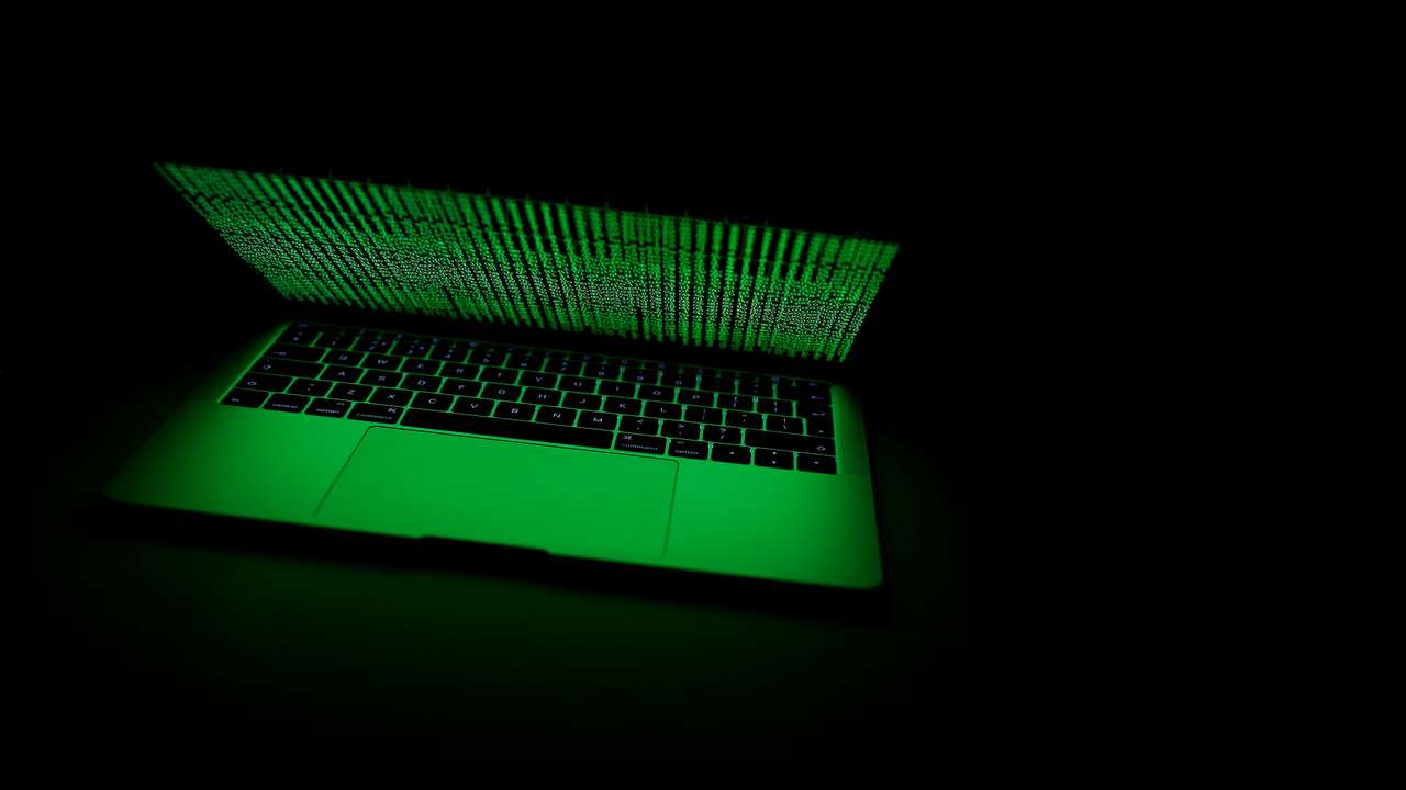 A computer lit by a displayed cyber code is seen in this illustration picture