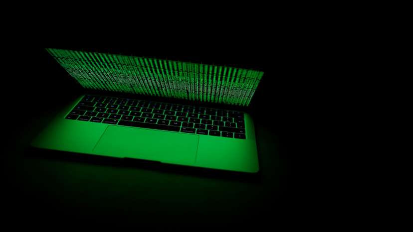 A computer lit by a displayed cyber code is seen in this illustration picture