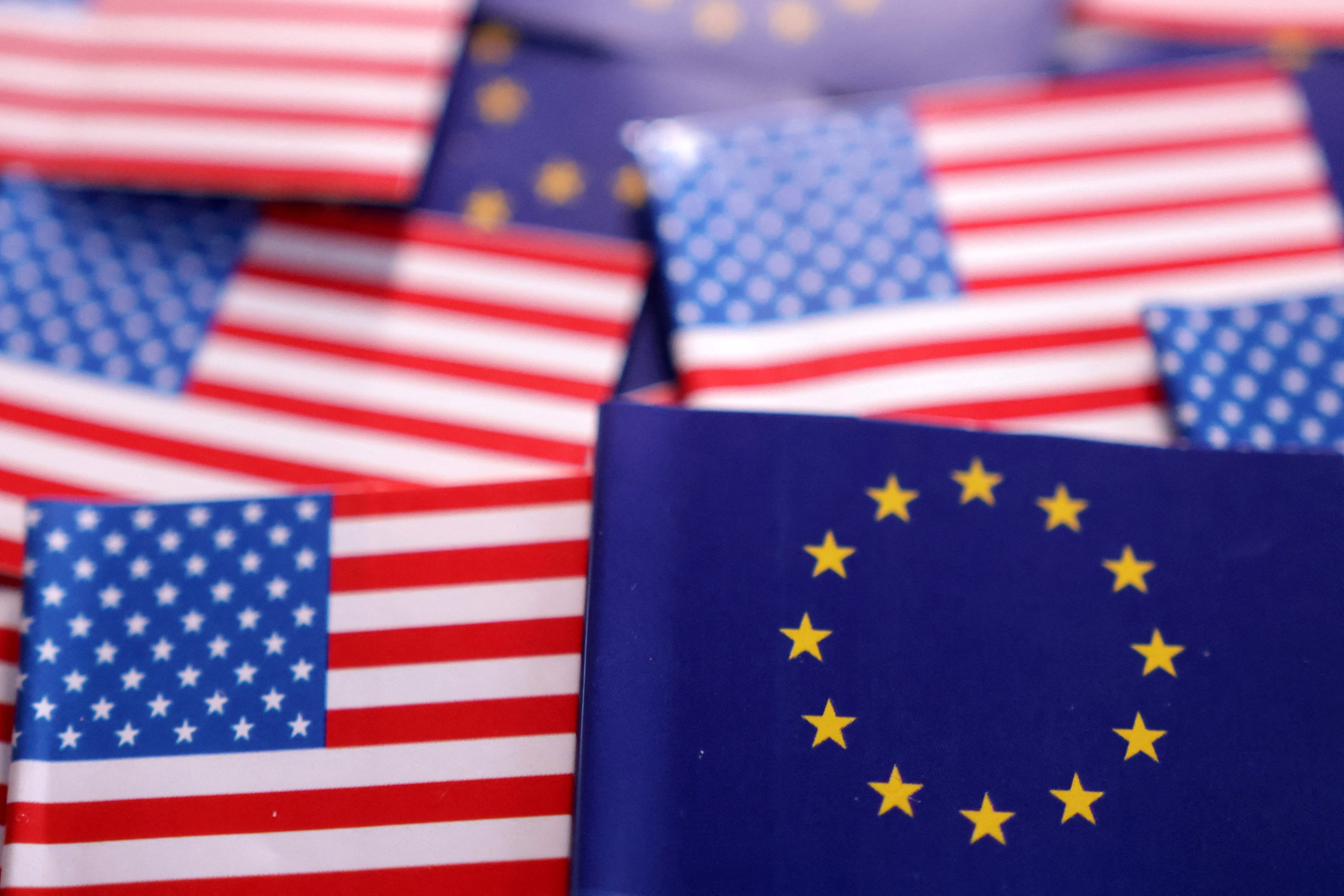Illustration shows U.S. and EU flags