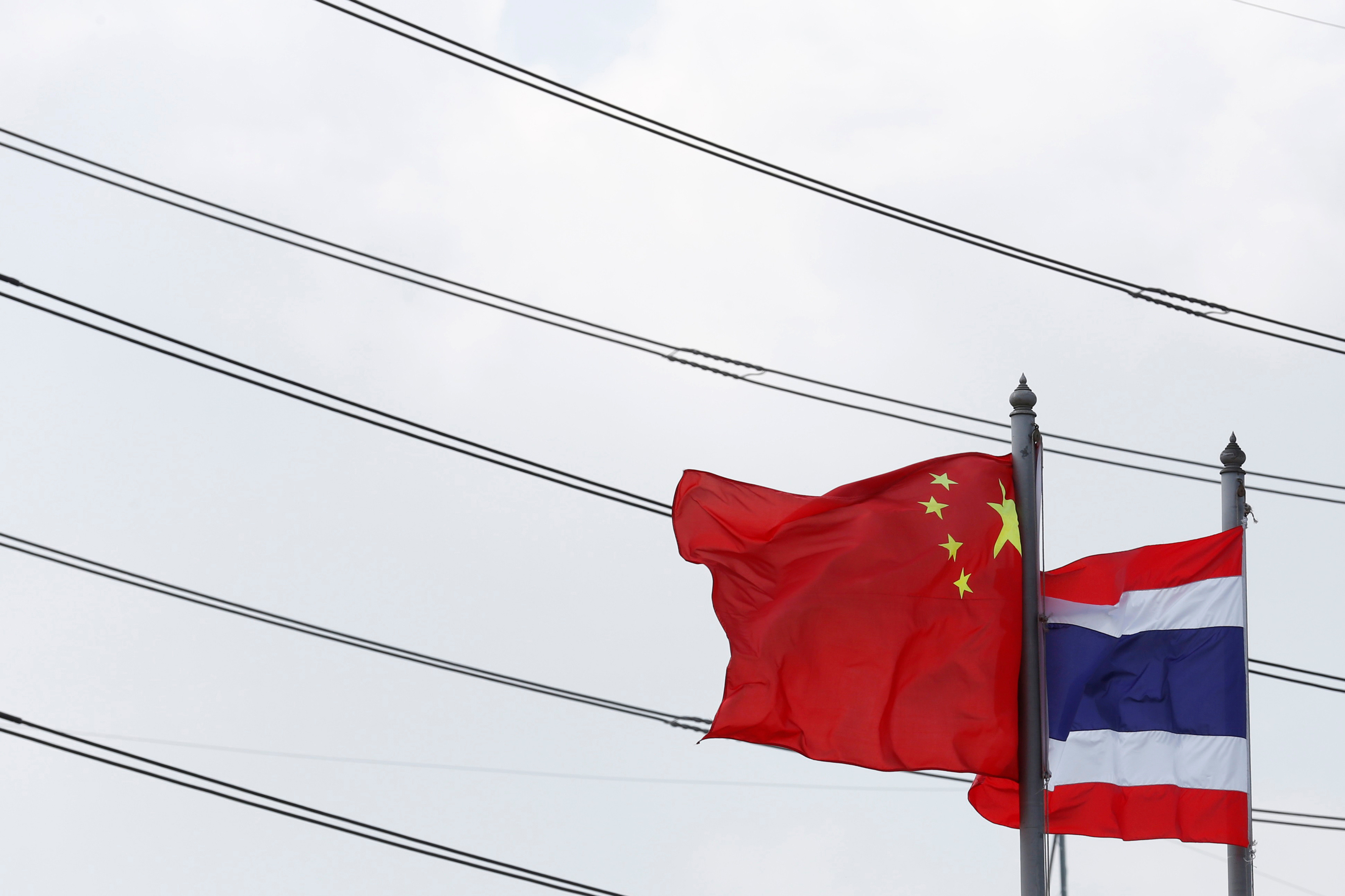 Flags flutter at an entrance of Thai-Chinese Rayong Industrial Zone in Rayong province