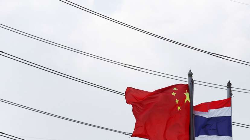 Flags flutter at an entrance of Thai-Chinese Rayong Industrial Zone in Rayong province