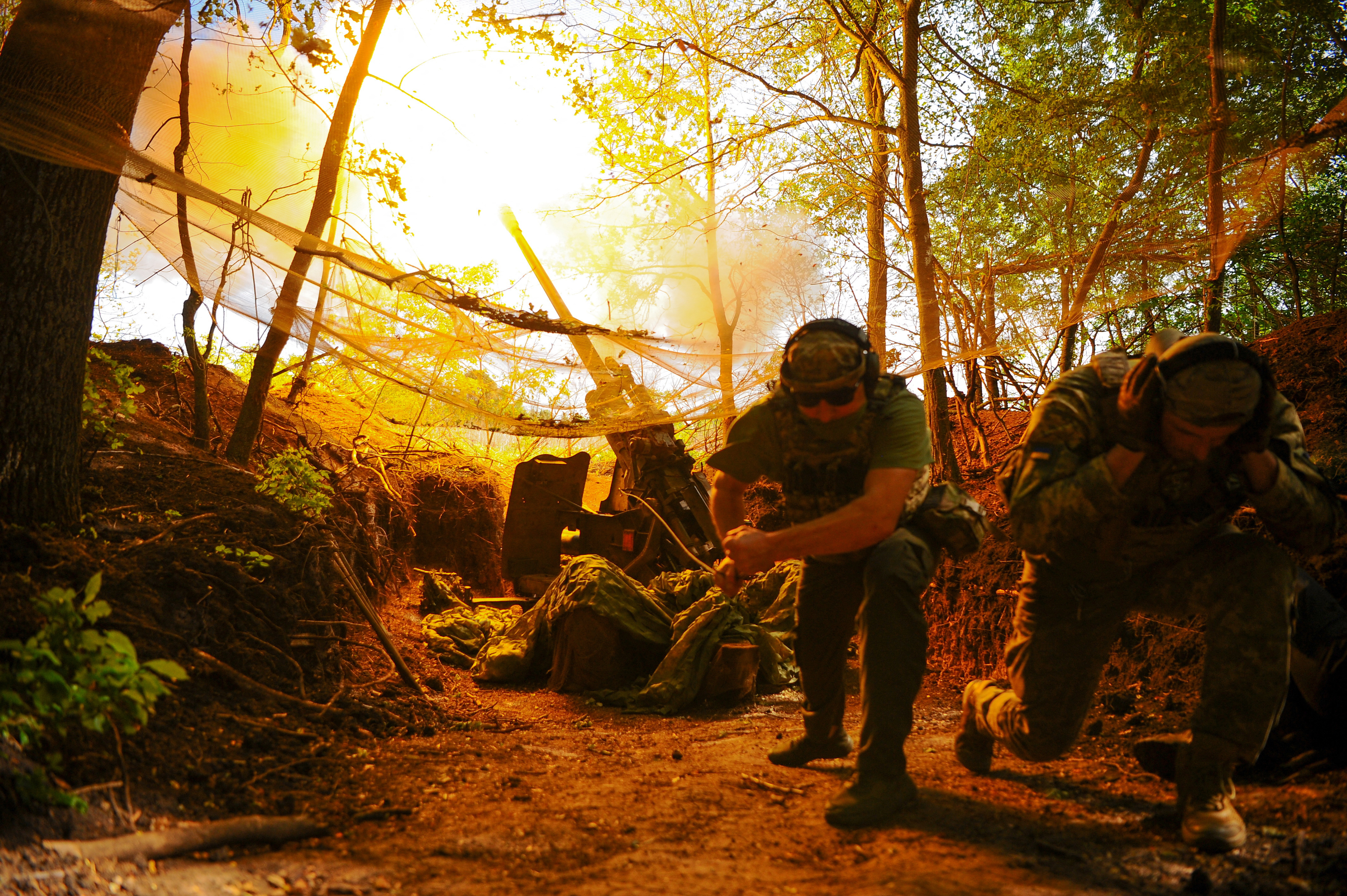 Ukrainian servicemen fire a self-propelled Howitzer towards Russian troops in a front line in Kharkiv region