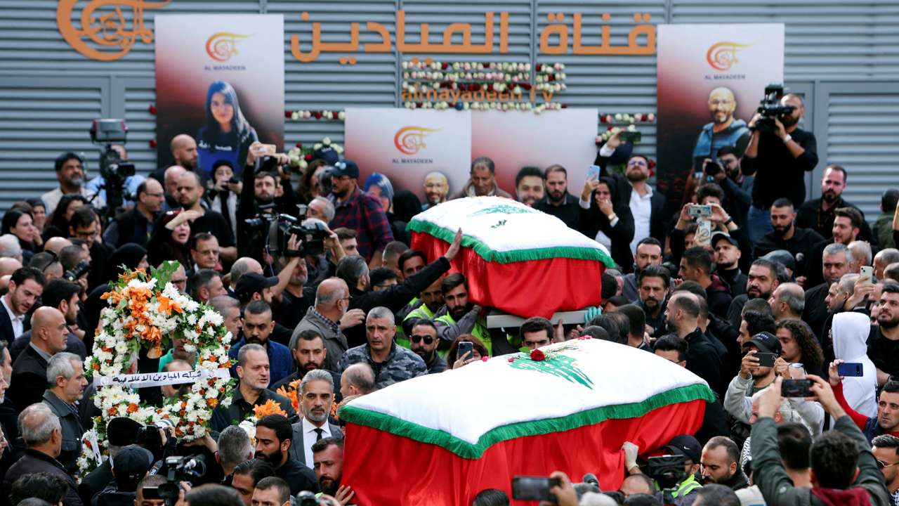 Mourners stand near the coffins of the two journalists working for Lebanon-based Al Mayadeen TV channel, in Beirut