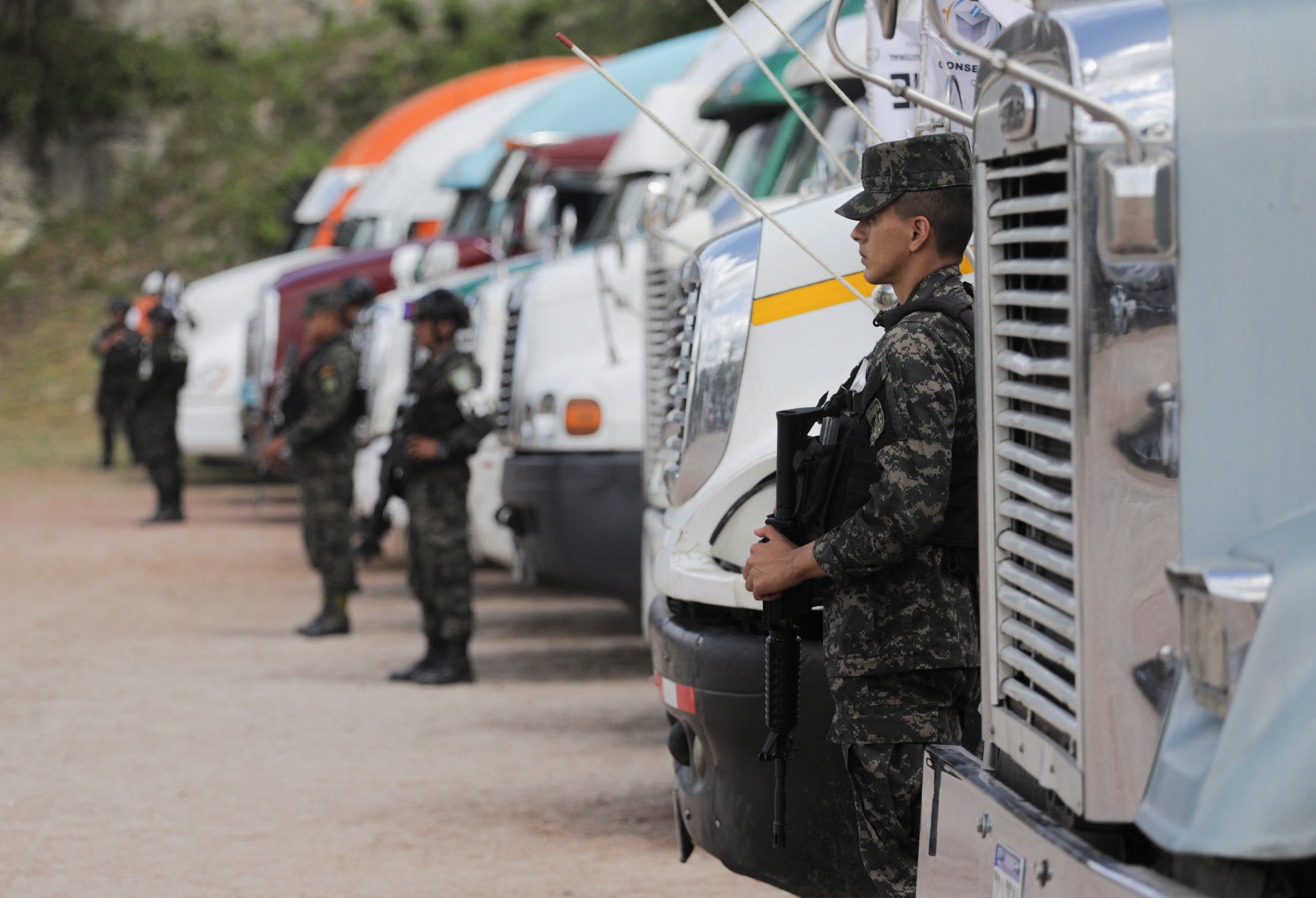 Members of security forces guard trucks holding ballot boxes, in Tegucigalpa