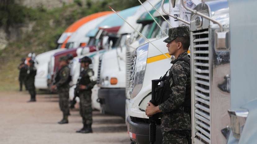 Members of security forces guard trucks holding ballot boxes, in Tegucigalpa