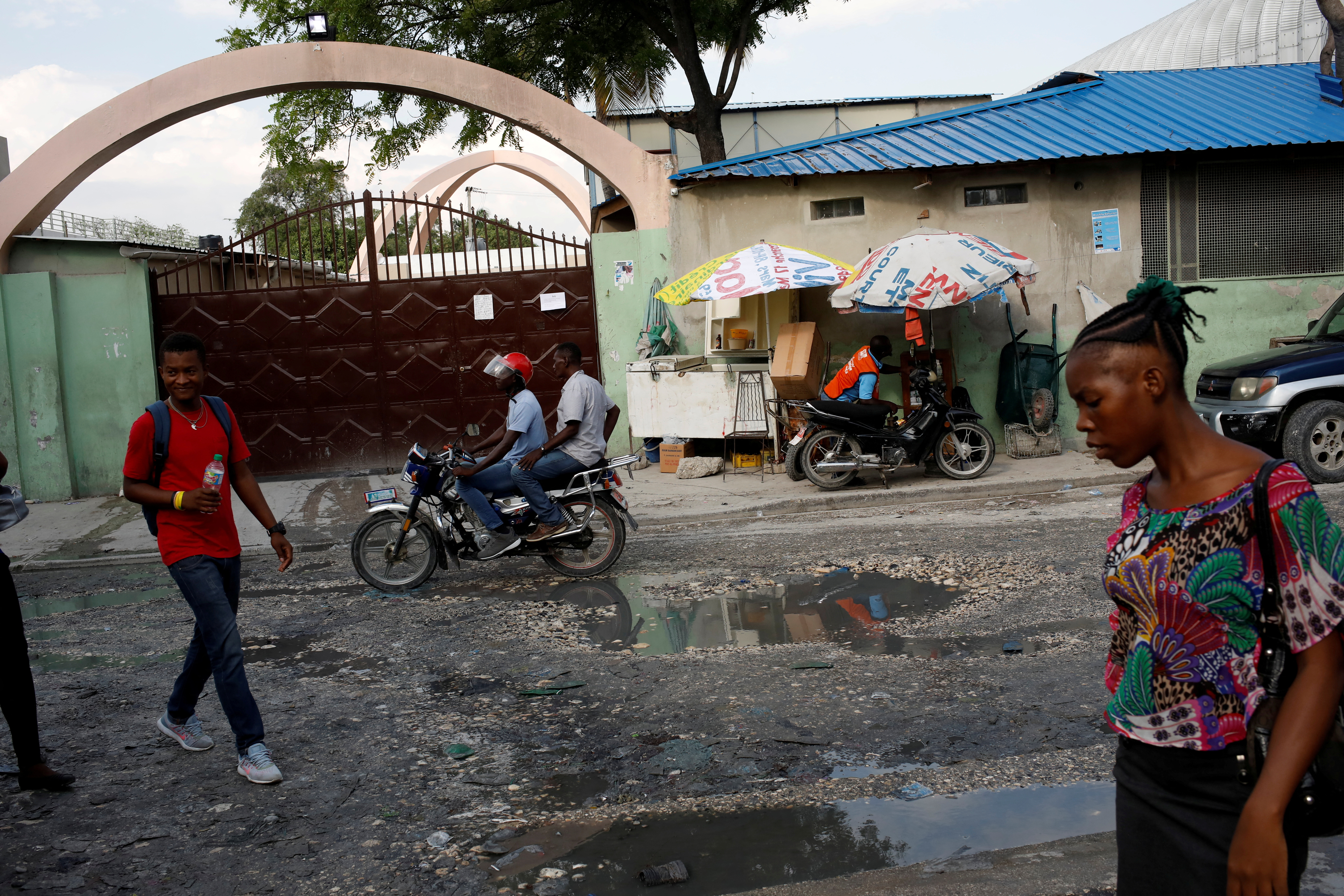 FILE PHOTO: People walk past Bernard Mevs Hospital in Port-au-Prince