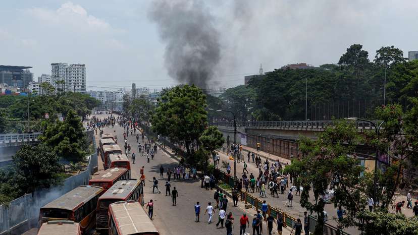 Smoke rises as anti-quota supporters clash with police and Awami League supporters at the Rampura area in Dhaka