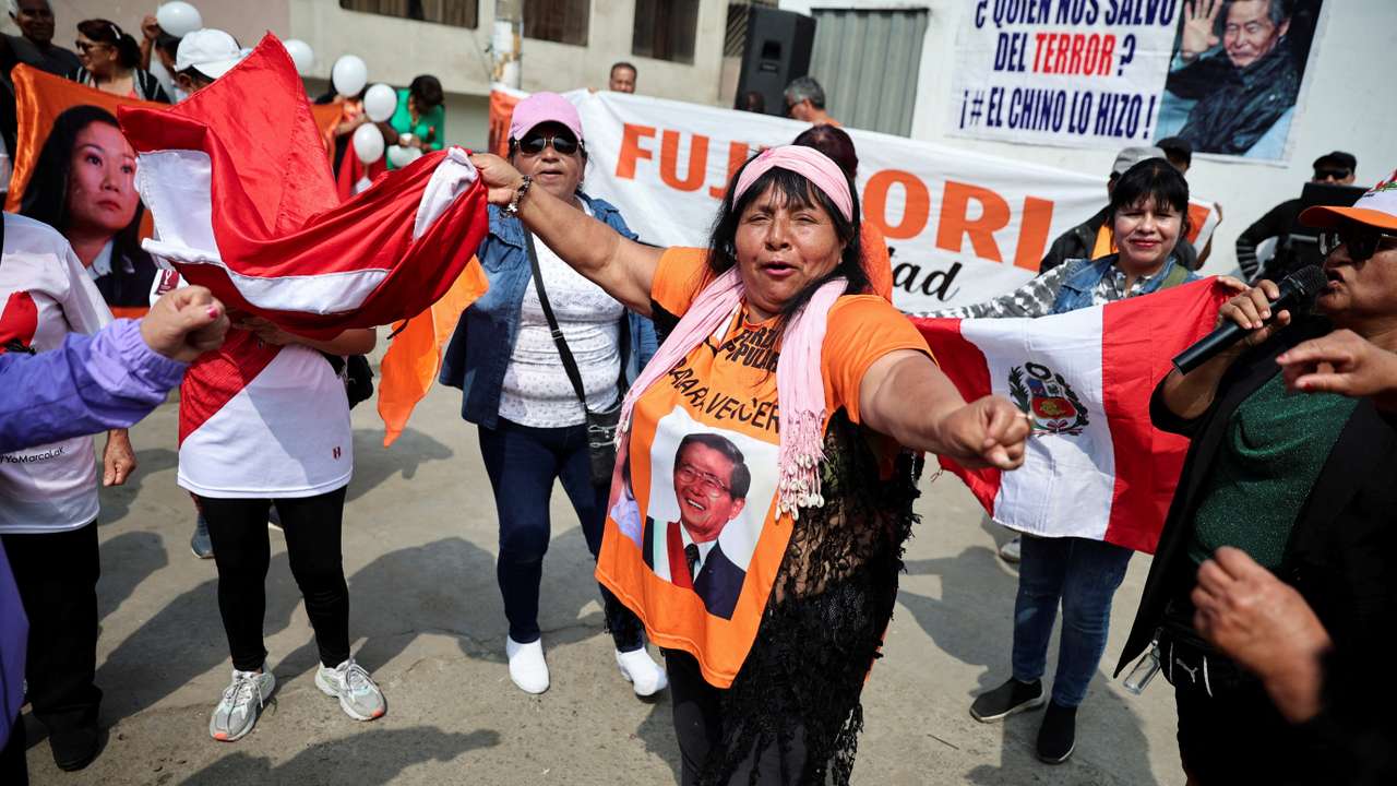 FILE PHOTO: People protest outside the prison where Peru's former President Alberto Fujimori is being held, in Lima