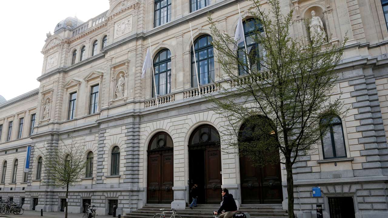 FILE PHOTO: A cyclist rides past a building of Ghent University