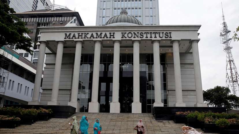 FILE PHOTO: Muslim women walk in front of Indonesia's constitutional court after attending a trial in Jakarta