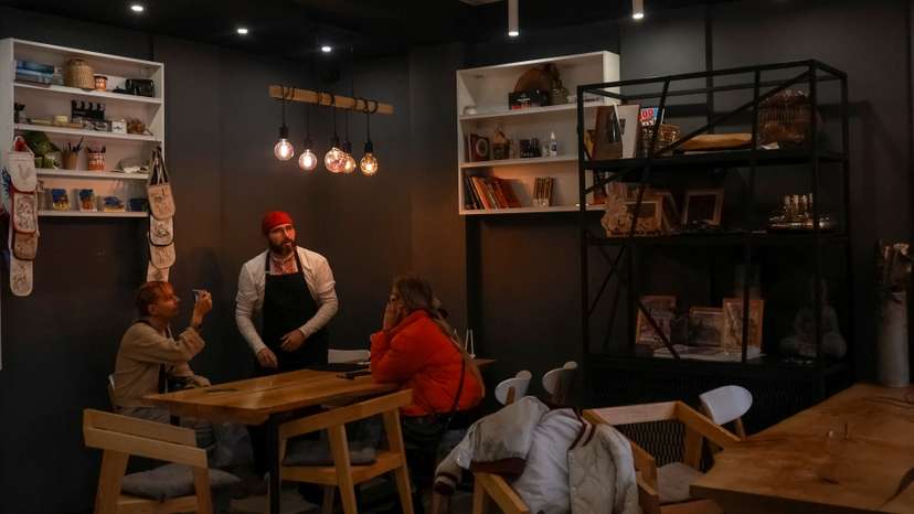 Cafe manager Melnychenko speaks with visitors in his cafe in Kherson