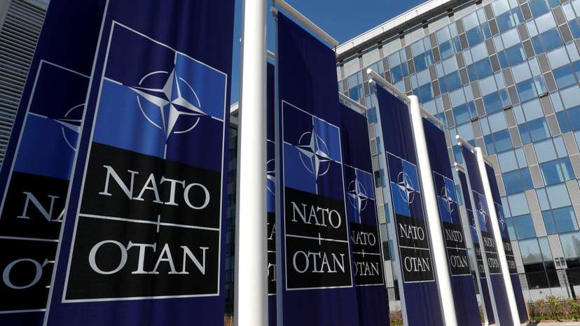 FILE PHOTO: Banners displaying the NATO logo are placed at the entrance of new NATO headquarters during the move to the new building