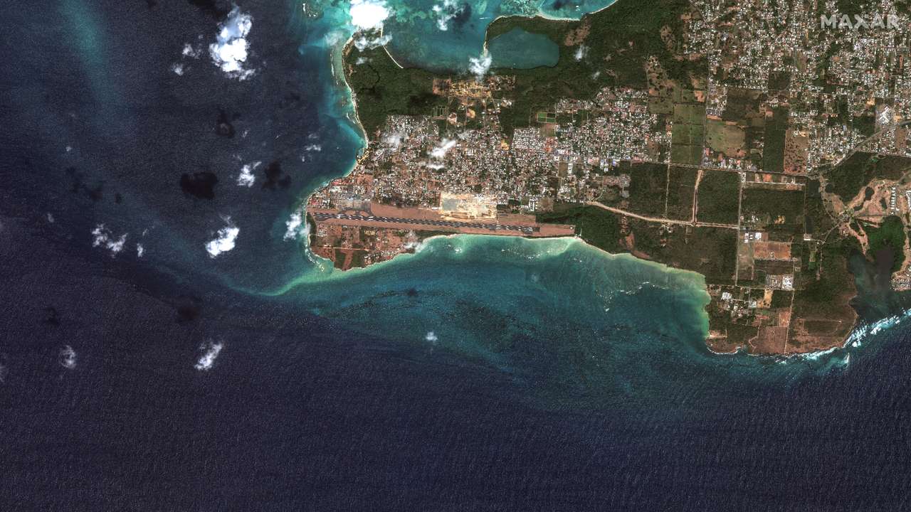 A satellite image shows an overview of an oil spill from a capsized barge off the shore of Tobago Island