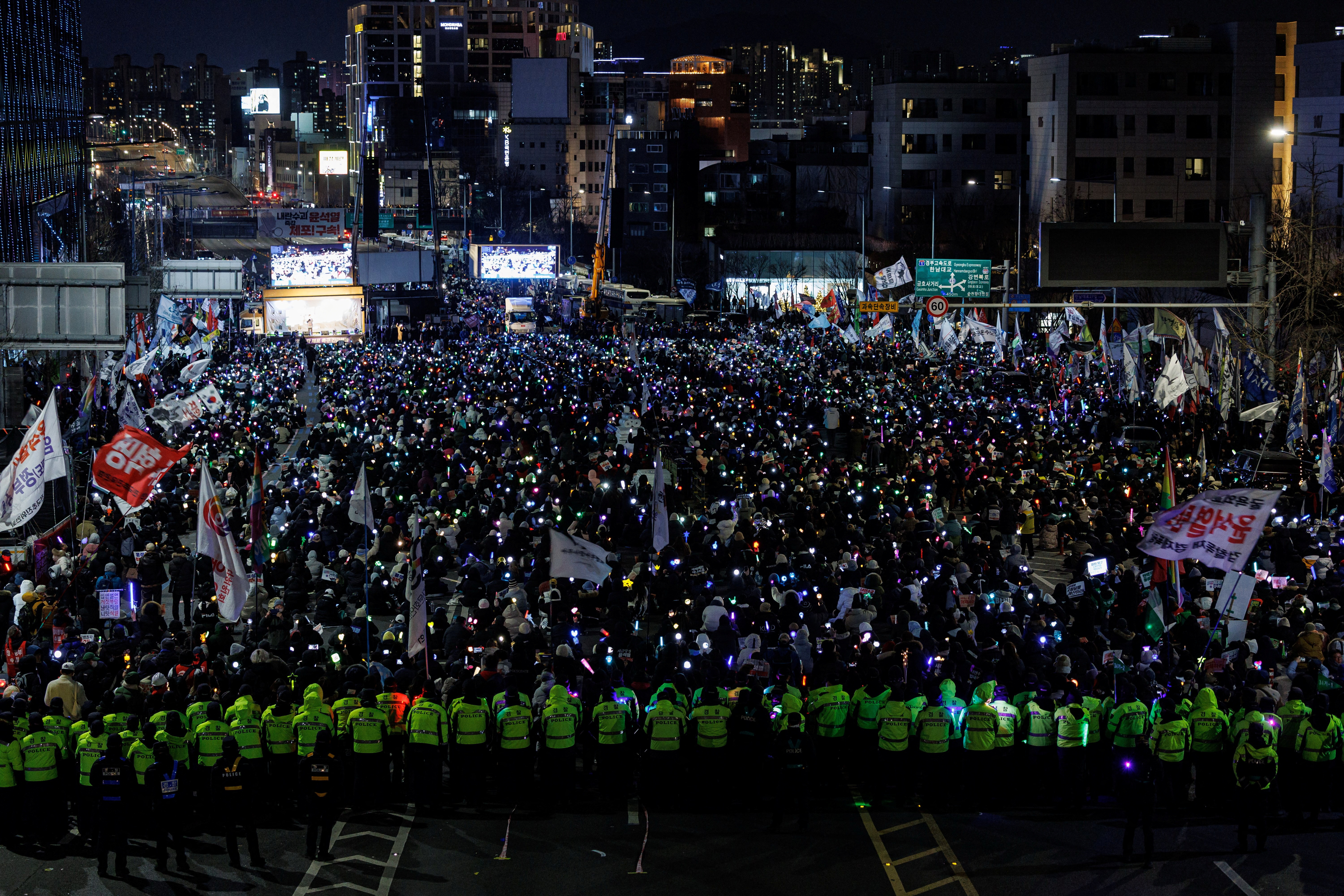 People take part in a protest against the impeached South Korean President Yoon Suk Yeol near his official residence, in Seoul