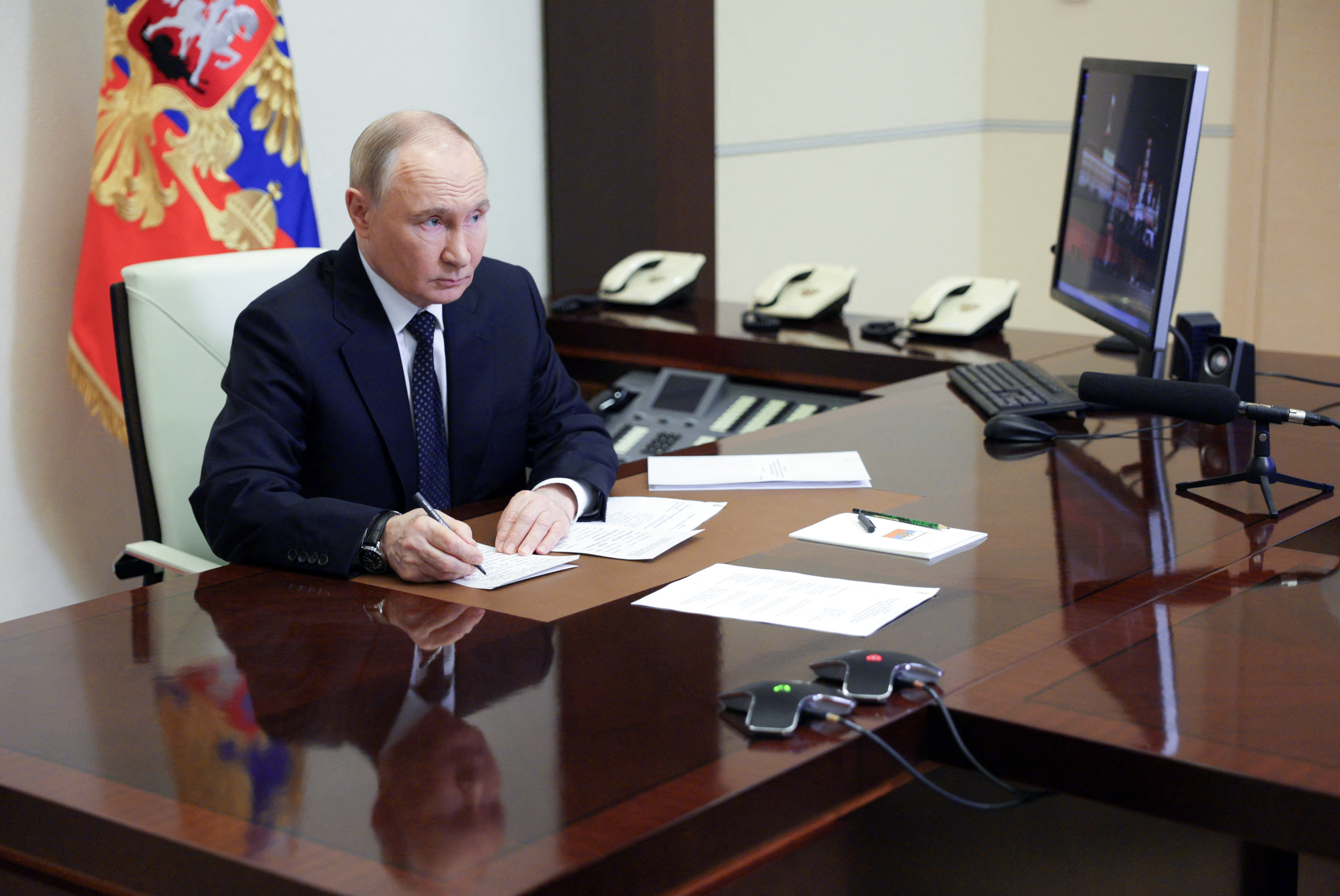 Russian President Putin chairs a meeting with members of the government via video link at a residence outside Moscow