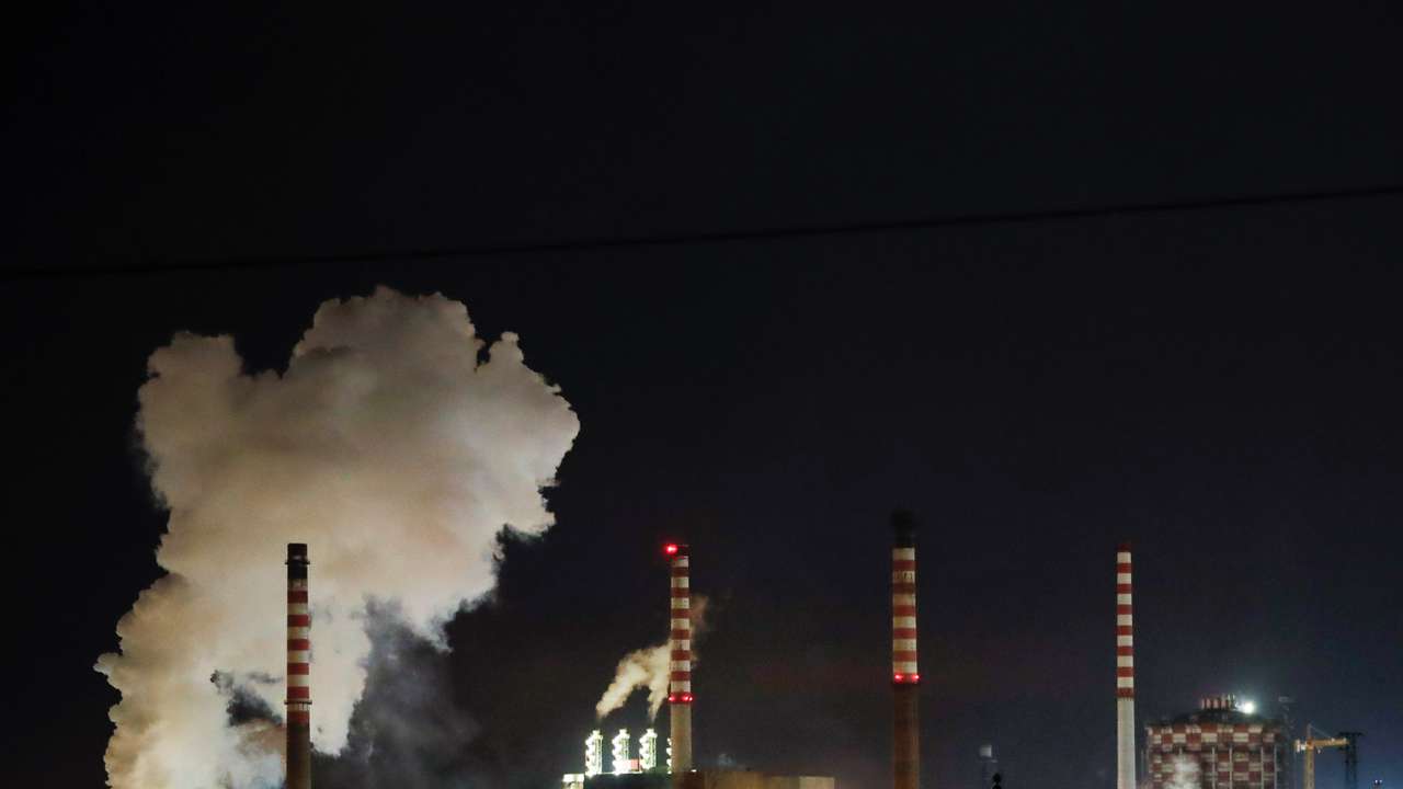 Steam comes out of the chimneys of Ilva steel plant in Taranto