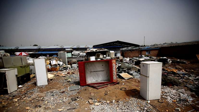 FILE PHOTO: Broken fridges are seen in the yard of a recycling workers' tenement house in Dongxiaokou village in Beijing