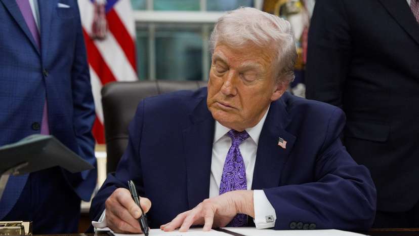 U.S. President Donald Trump signs an executive order in the Oval Office of the White House