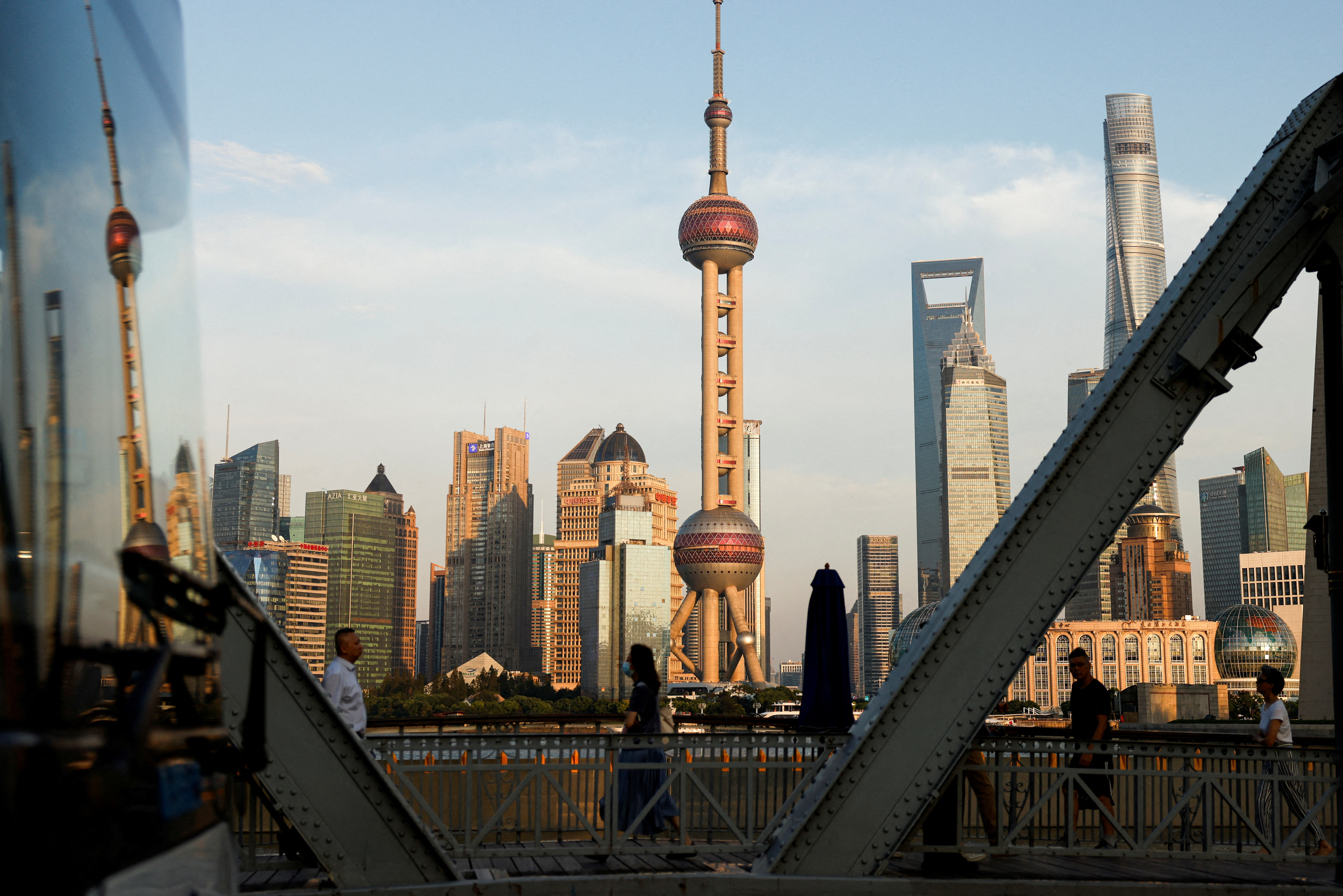 FILE PHOTO: View of financial district of Pudong is reflected on a bus passing by, in Shanghai
