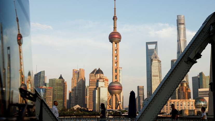 FILE PHOTO: View of financial district of Pudong is reflected on a bus passing by, in Shanghai