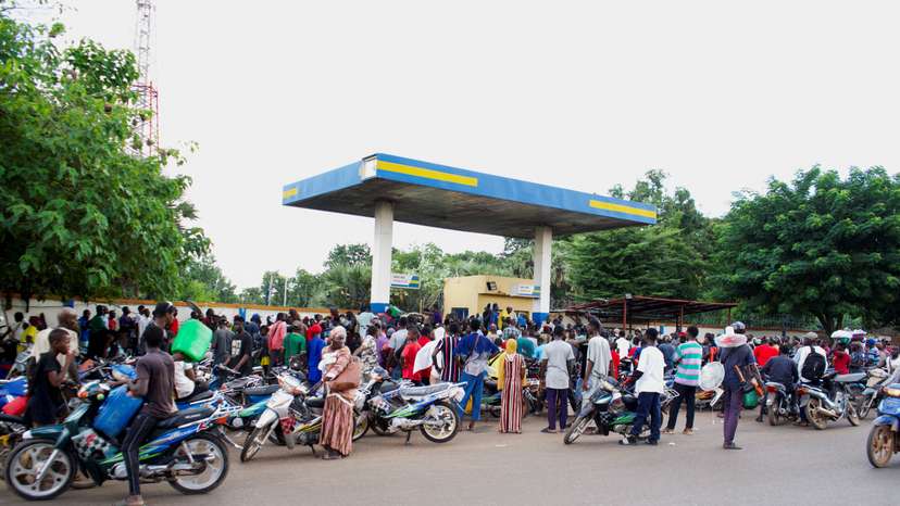 FILE PHOTO: People gather at a petrol station due to shortage of petrol in Bamako