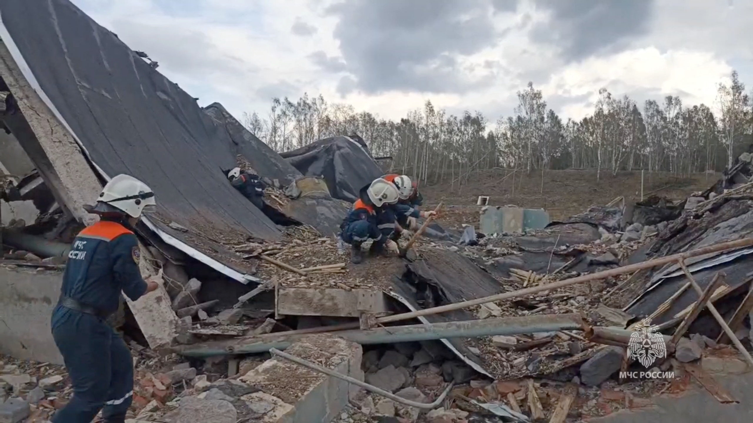 Members of Russian Emergencies Ministry clear debris at the site of a blast at a production facility in Ryazan Region