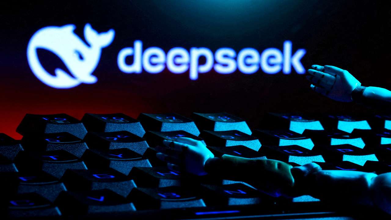FILE PHOTO: Illustration shows deepseek logo, keyboard, and robot hands