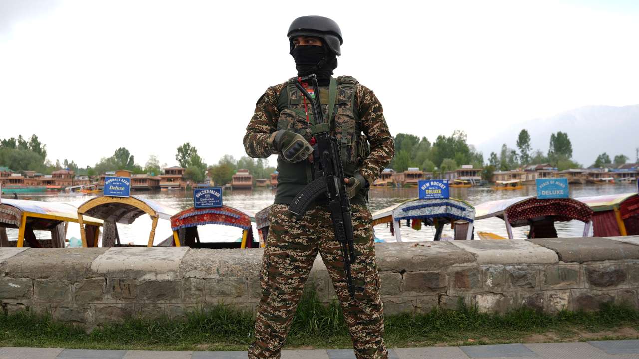 An Indian security force personnel stands guard on the banks of Dal Lake, in Srinagar