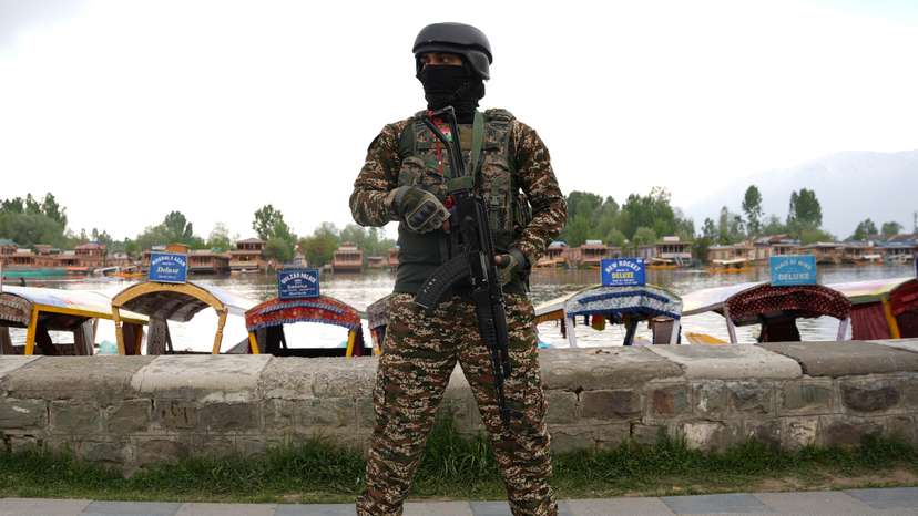 An Indian security force personnel stands guard on the banks of Dal Lake, in Srinagar