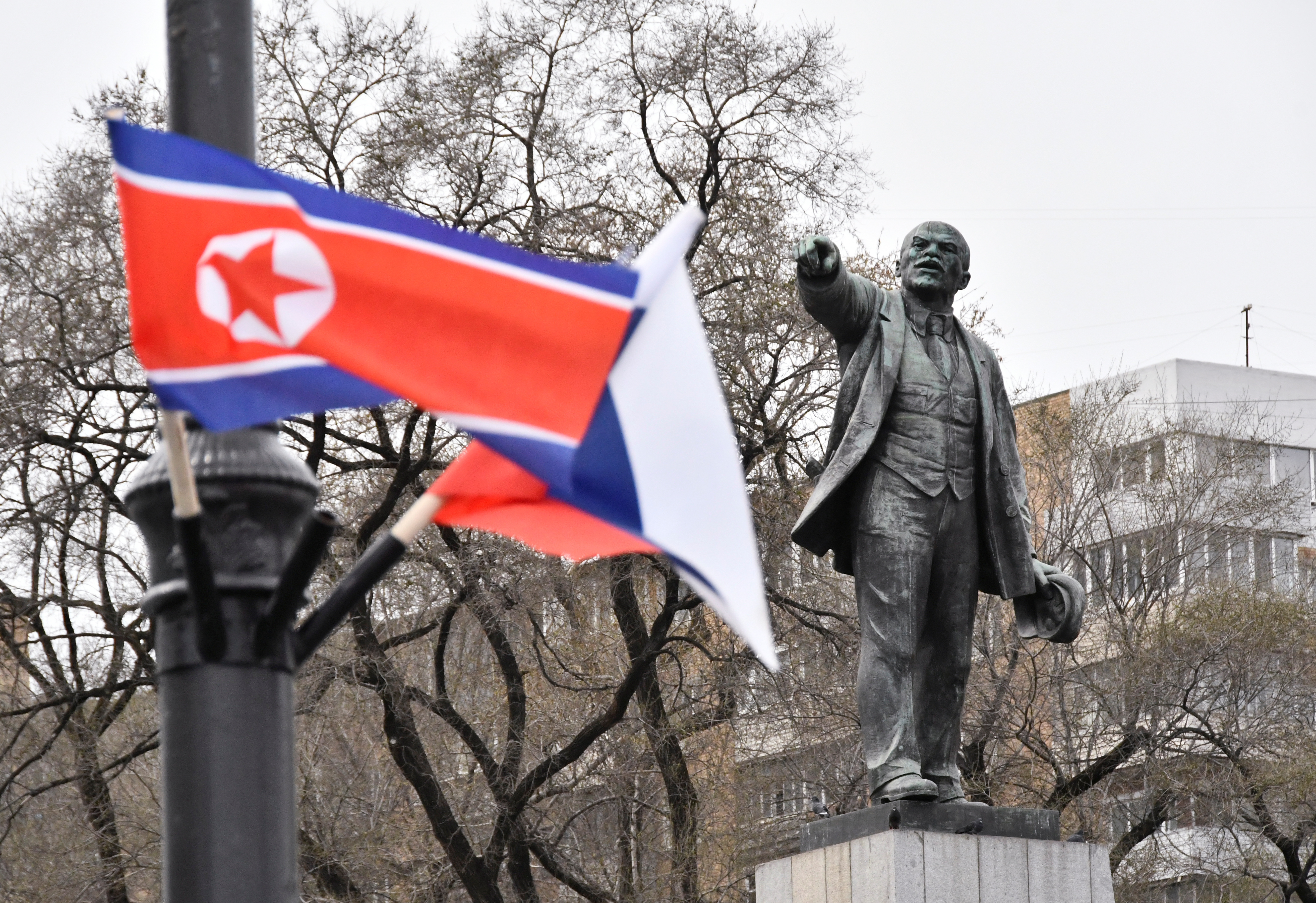 State flags of Russia and North Korea fly in a street in Vladivostok
